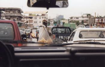Pineapple hawker in Third World traffic